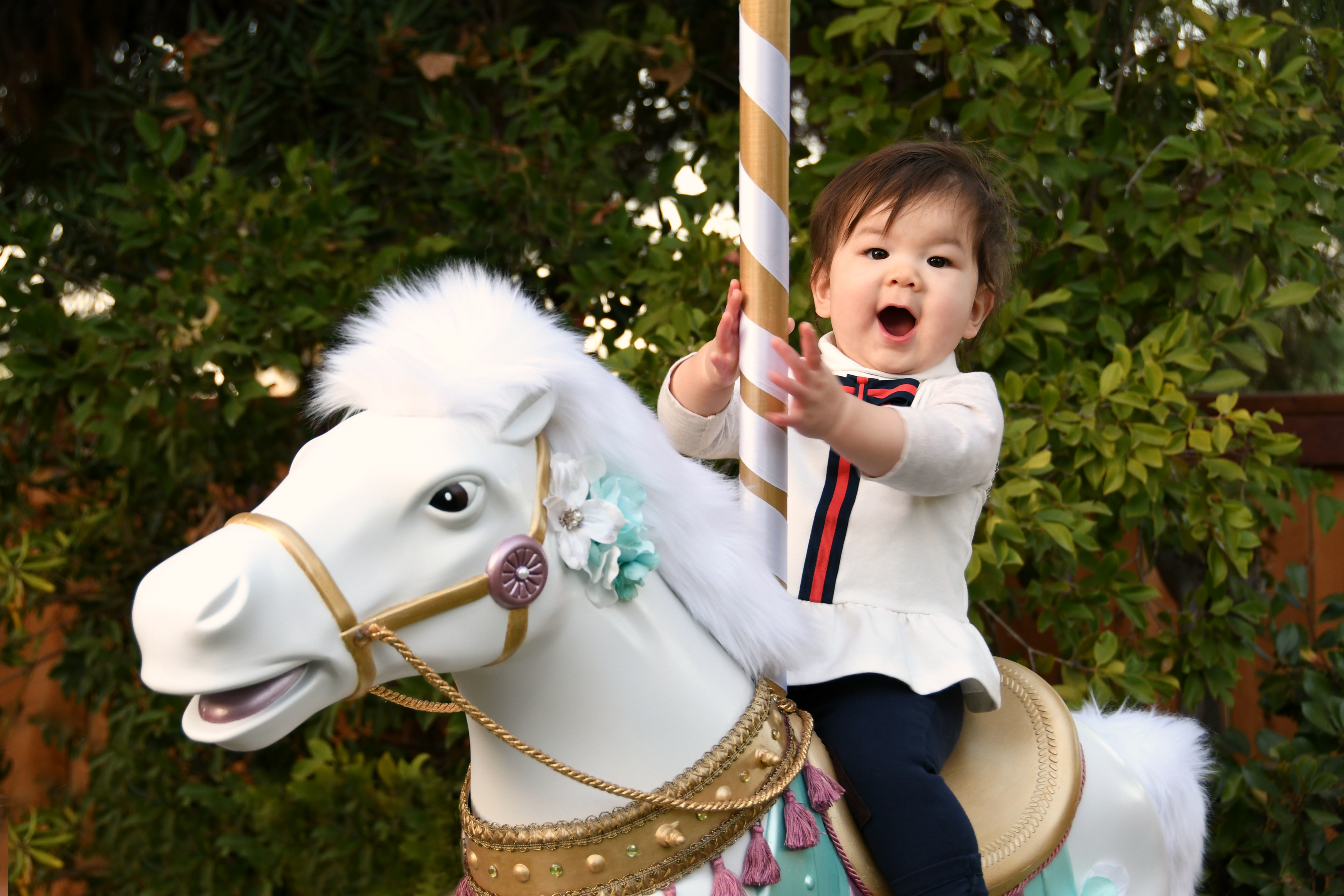 Girl riding white diy carousel horse decoration